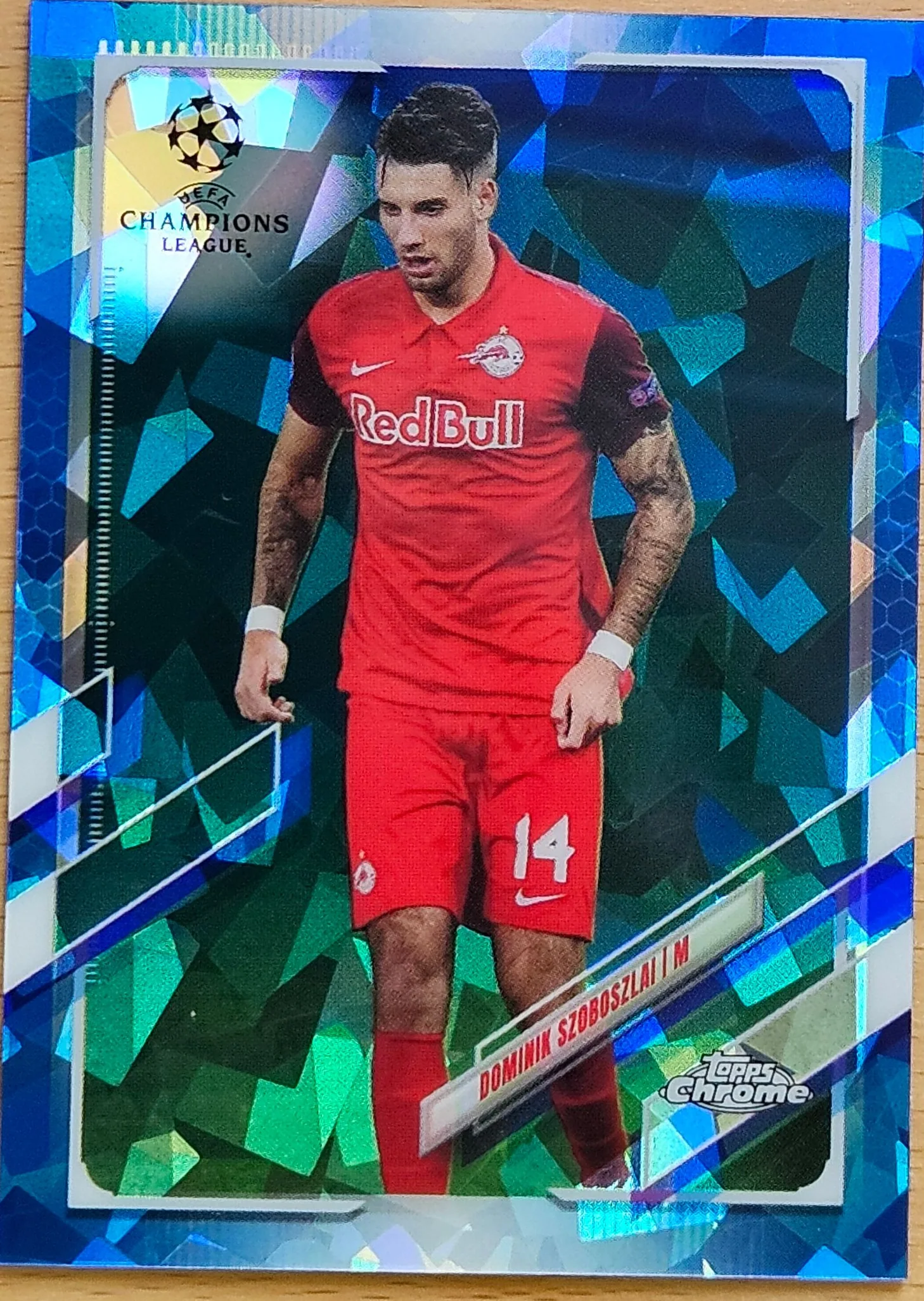 front of Dominik Szoboszlai's Topps Chrome UEFA Champions League card at high resolution