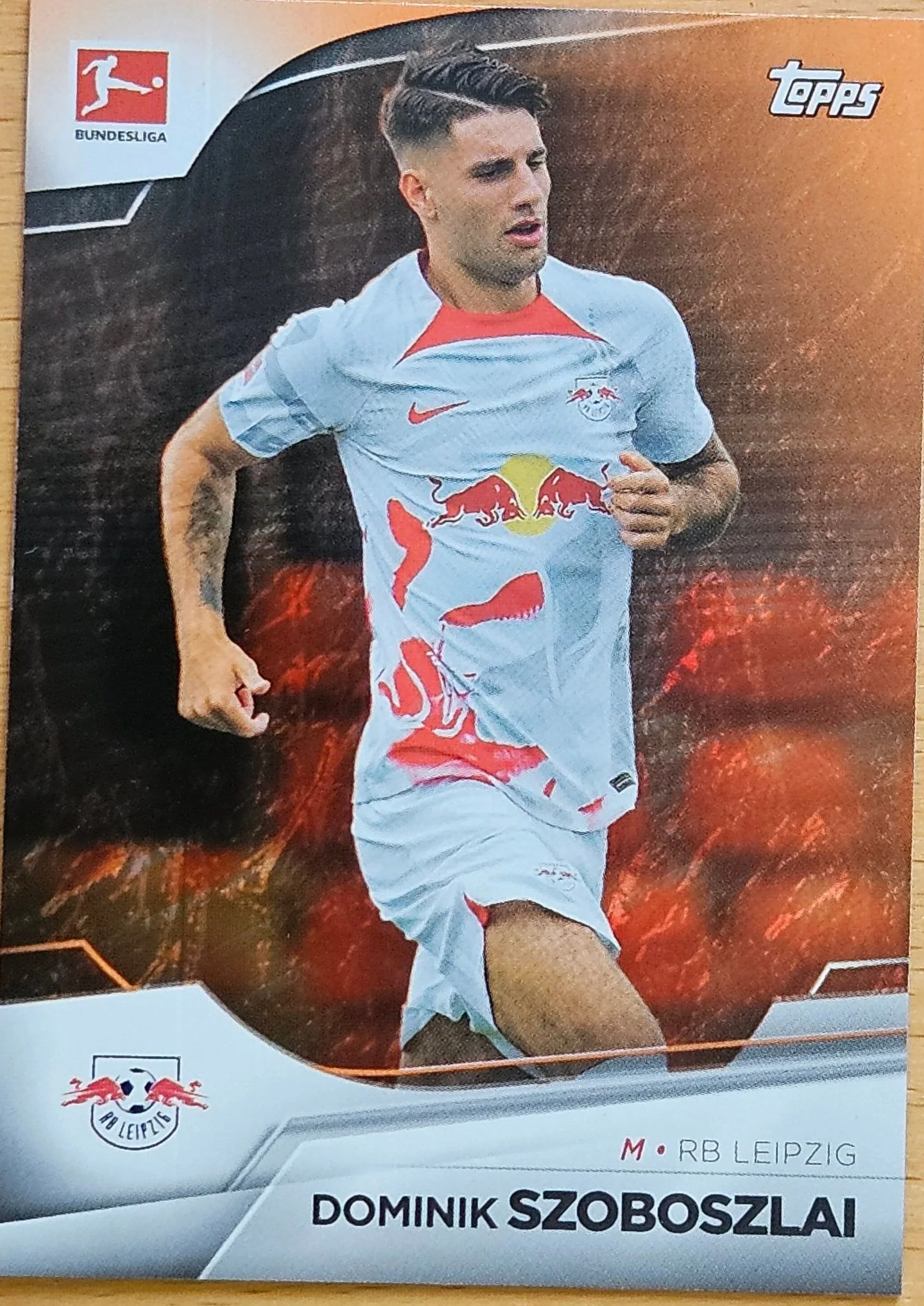 front of Dominik Szoboszlai's Topps Bundesliga card at high resolution