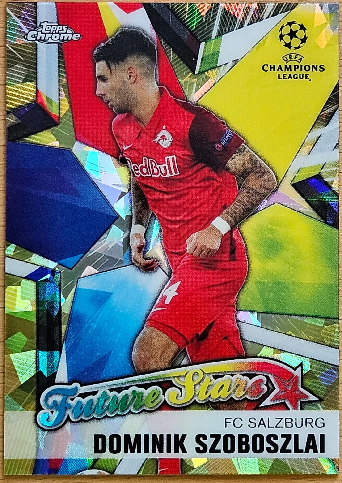front of Dominik Szoboszlai's Topps Chrome UEFA Champions League card at high resolution