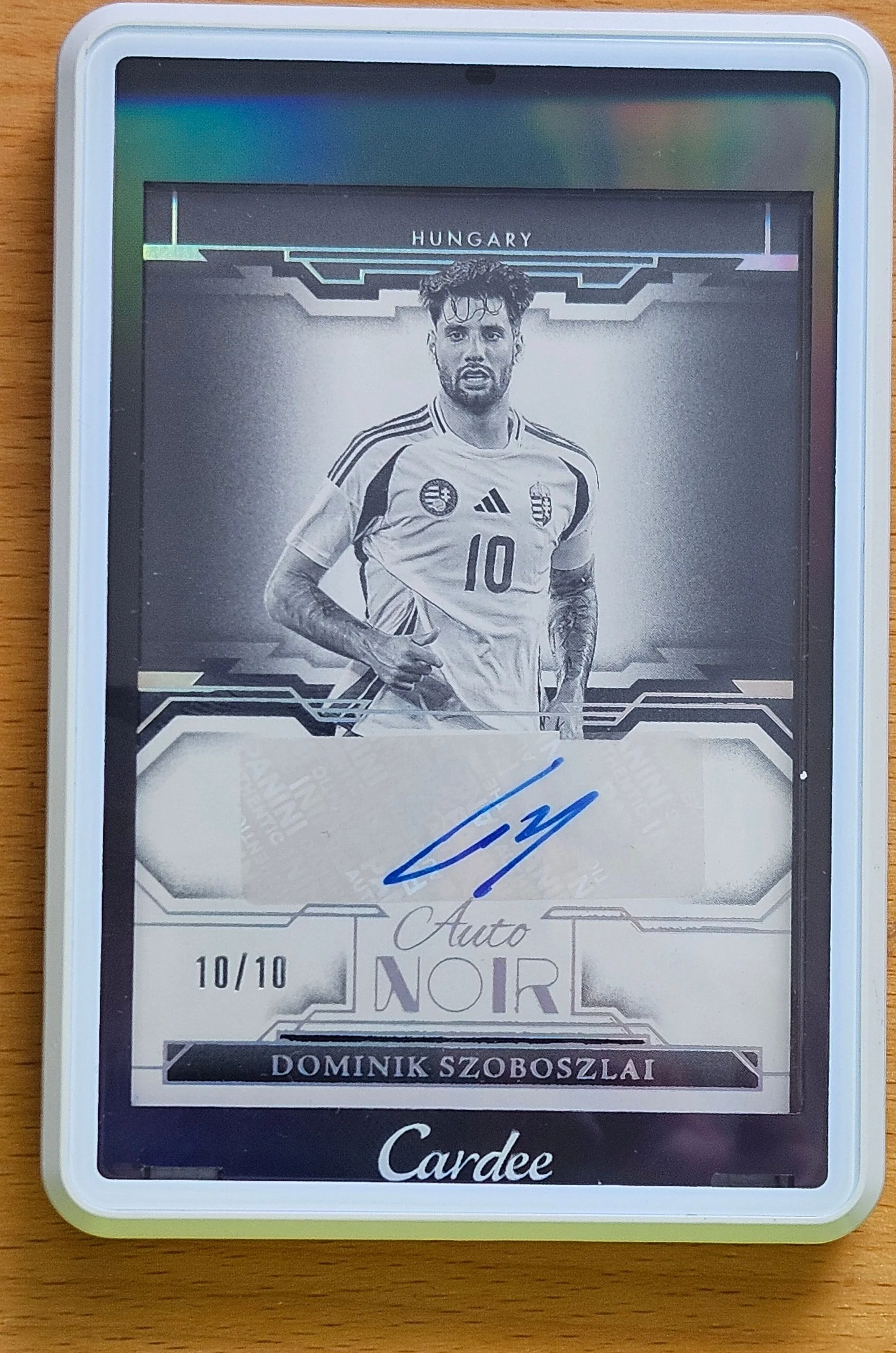 front of Dominik Szoboszlai's Panini Noir Soccer card at high resolution